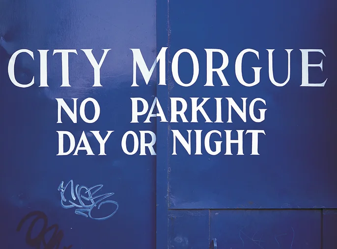 photograph of the blue, steel back gates of the City Morgue
