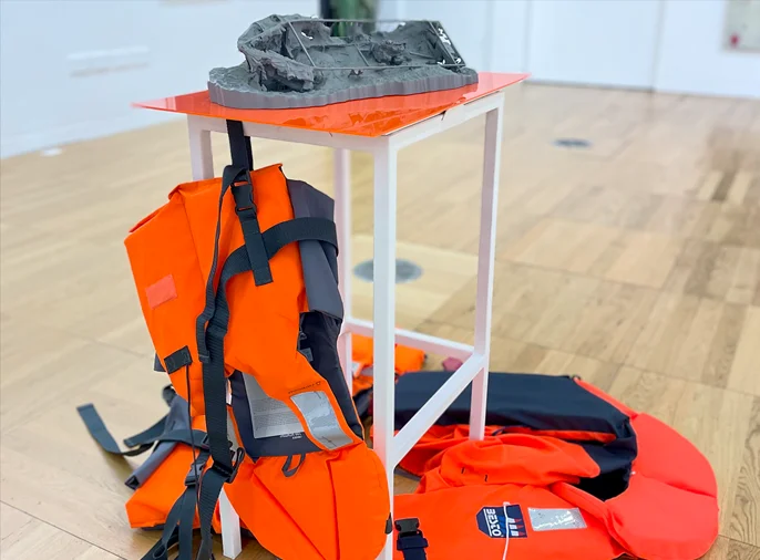 photograph of sculpture of 3d printed model of boat and lifejackets