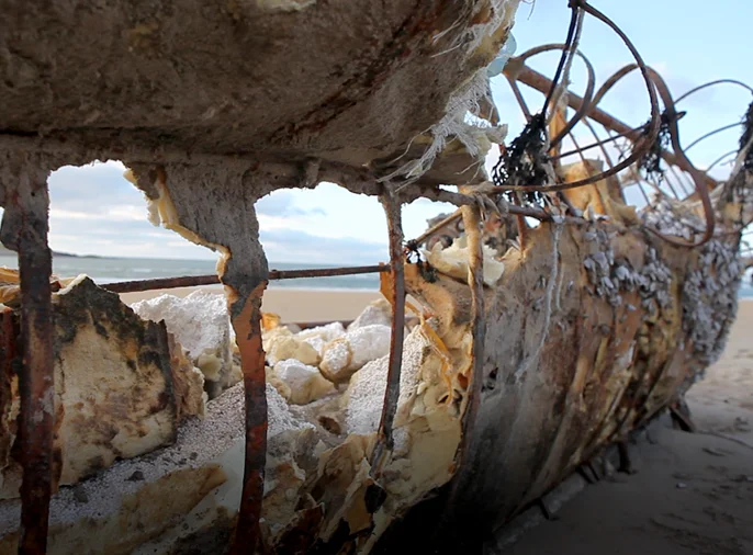 photo of boat washed up on beach